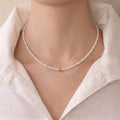 Woman wearing a 3–3.5mm freshwater pearl necklace with 18K solid gold accents for a refined minimalist jewelry look.