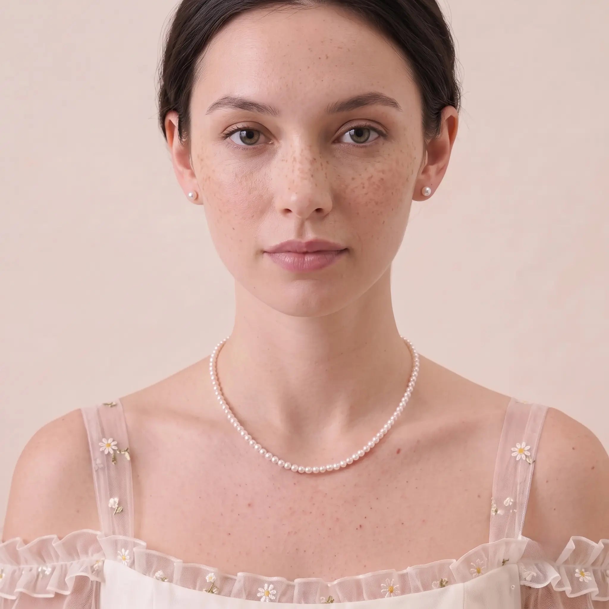 Elegant woman wearing a solid gold freshwater pearl necklace and earrings set for a timeless wedding or special occasion look.
