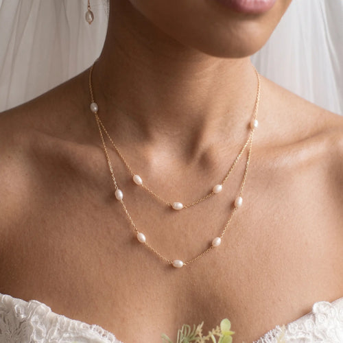 Bride wearing an 18K solid gold double layer pearl necklace for a sophisticated and timeless wedding jewelry look.