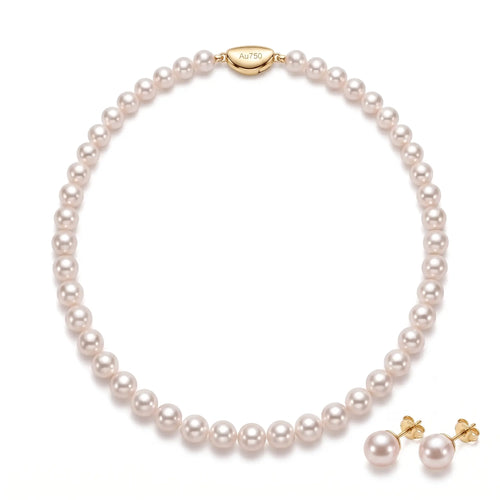 Solid gold freshwater pearl necklace and earrings set featuring hand-selected pearls with a timeless minimalist design.