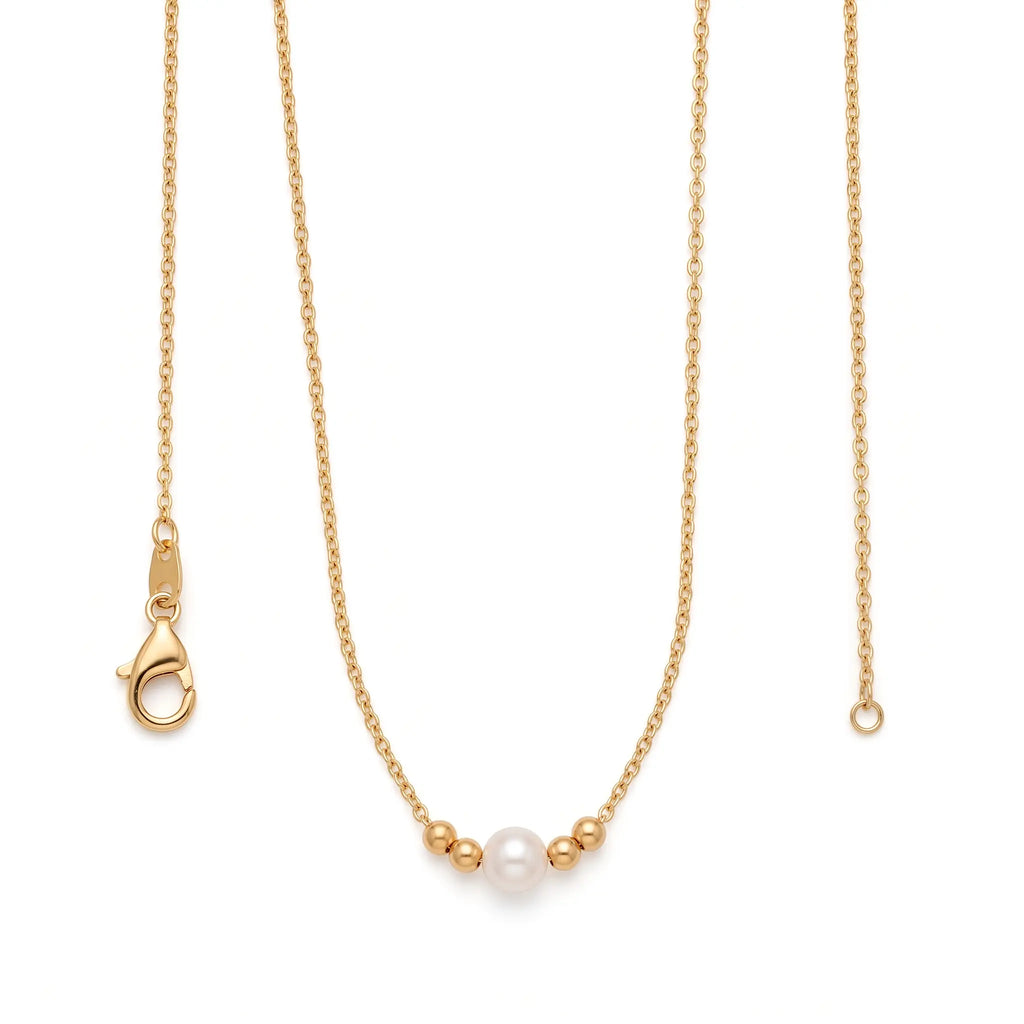 Close-up of an 18k solid gold solitaire pearl necklace featuring a hand-selected 7-7.5mm genuine pearl flanked by two real gold beads.