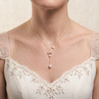 Bride wearing an 18K solid gold baroque pearl Y-lariat necklace for a modern romantic bridal jewelry look.