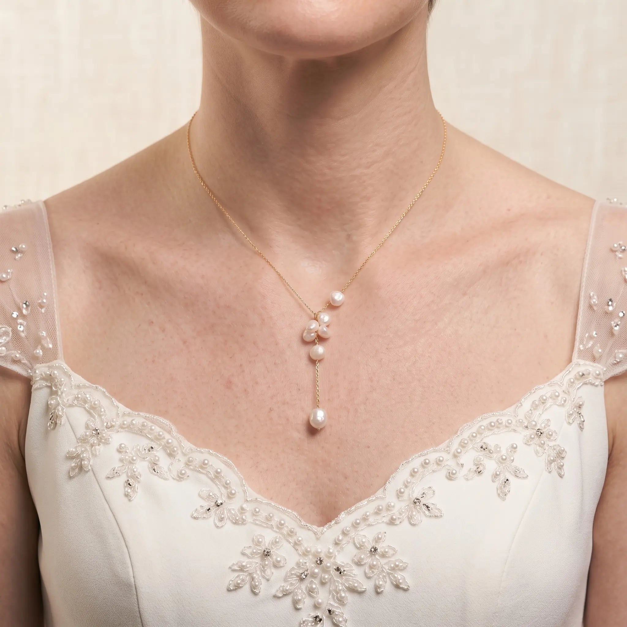 Bride wearing an 18K solid gold baroque pearl Y-lariat necklace for a modern romantic bridal jewelry look.