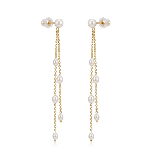Studio still life of a pair of minimalist long fluid twin-line rice pearl tassel earrings crafted in solid 18K yellow gold, focusing on the vertical silhouette.