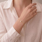 Close-up shot of a professional woman styling the 7-7.5mm Akoya gold bracelet with office attire, illustrating its skin-brightening radiance.