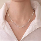 Woman wearing a dainty baby pearl necklace for an effortless French-inspired everyday jewelry look.