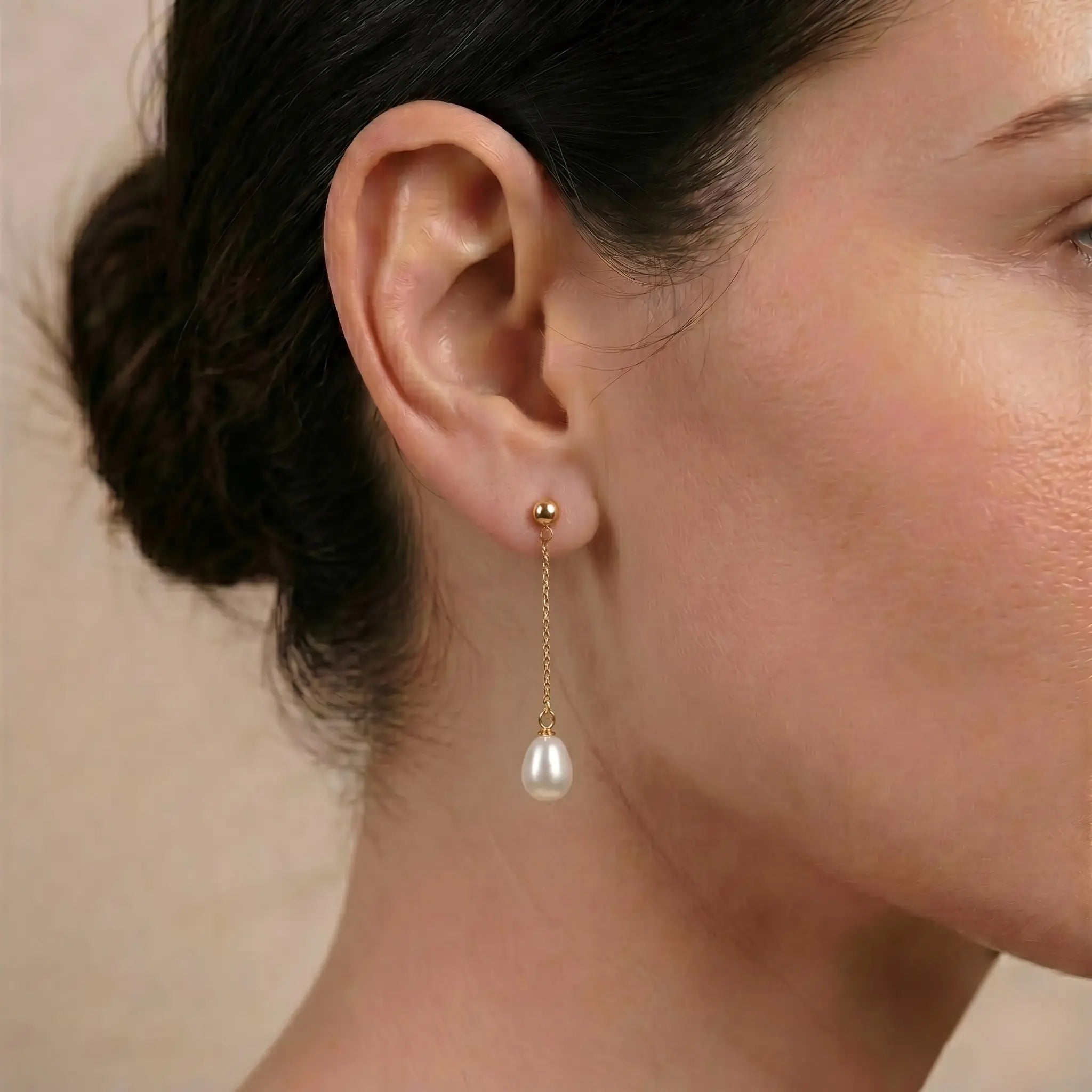Side profile of a woman wearing Taihu freshwater rice pearl threader earrings, highlighting the graceful drop and elongated silhouette.