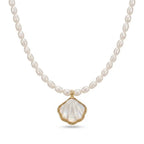 Close-up of an AAA grade rice freshwater pearl necklace with a polished gold shell pendant.