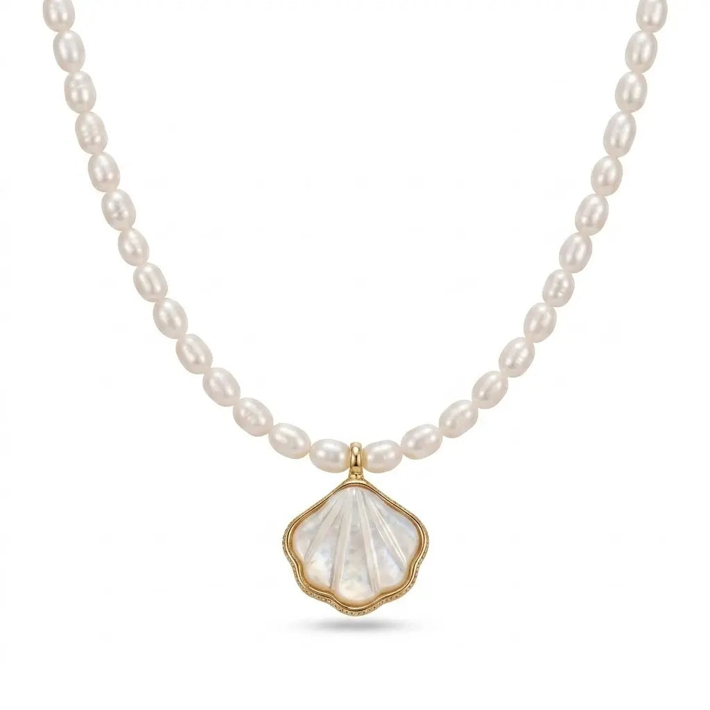 Close-up of an AAA grade rice freshwater pearl necklace with a polished gold shell pendant.