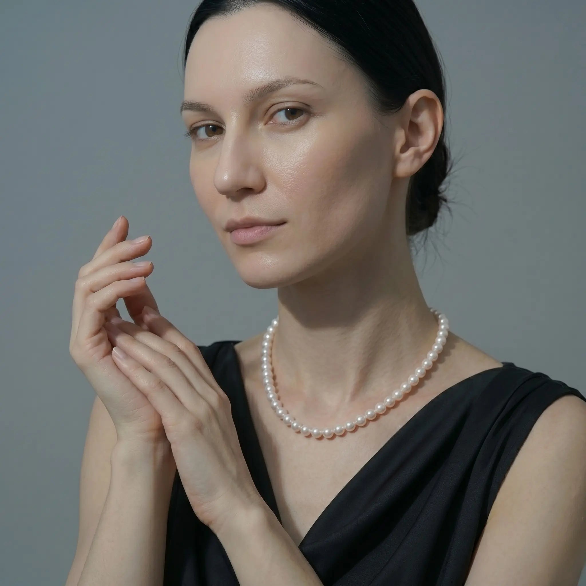 Close-up of a high-lustre white freshwater pearl strand necklace, showcasing individual natural pearls