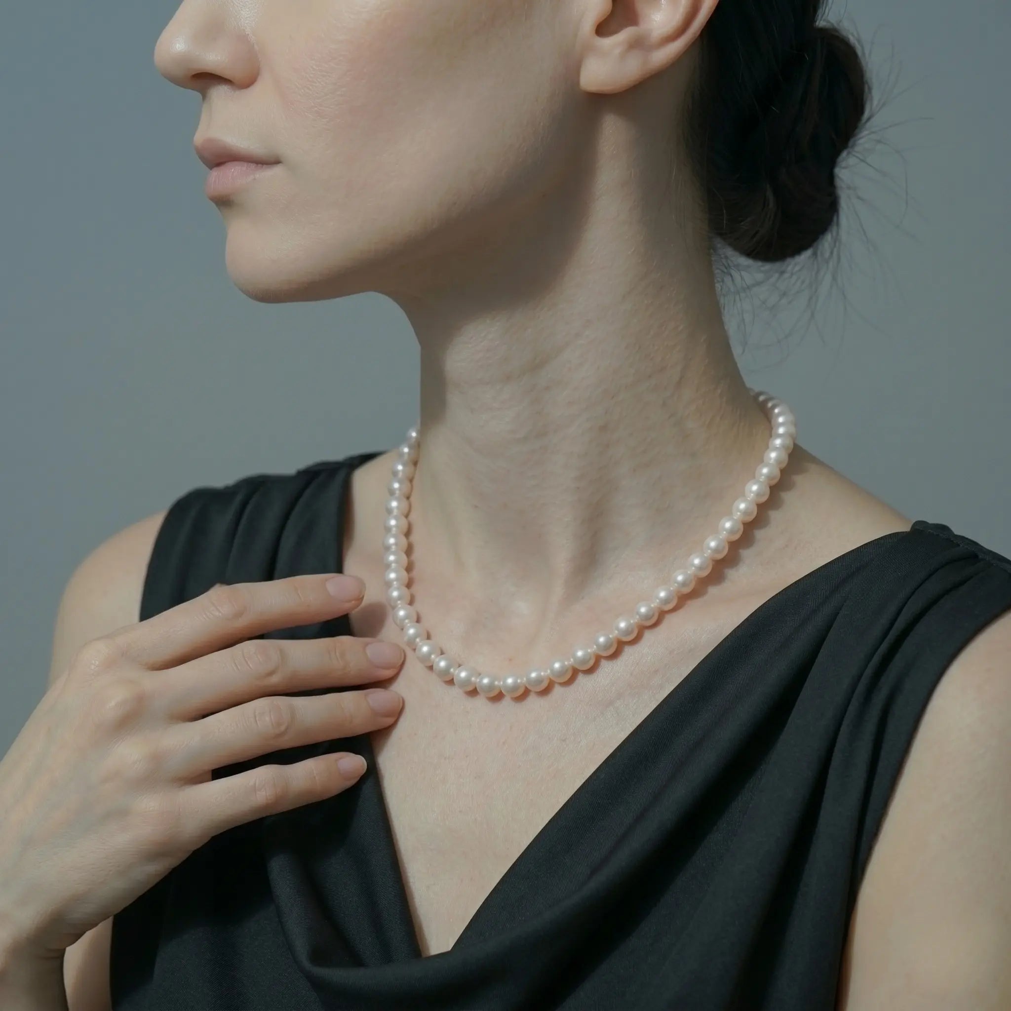 A classic round white freshwater pearl necklace with a polished sterling silver clasp