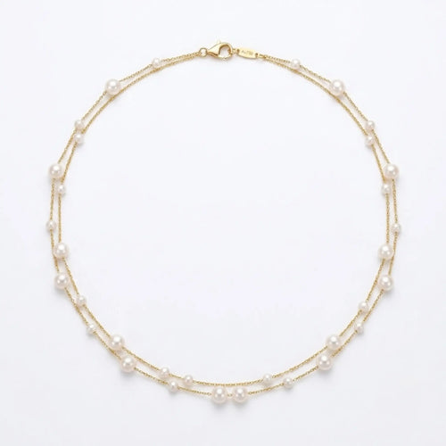 18K solid yellow gold double strand station necklace with a dual-size gradient of 3mm and 5mm genuine white pearls on pre-nested chains.