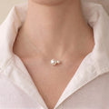 A close-up of a model's collarbone wearing a floating double pearl necklace, showing the 5mm and 7.5mm pearls appearing to float directly on the skin.