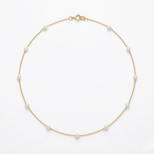 Onepearlife fine 18K solid gold choker necklace flat lay on a stark white background, showcasing a delicate sequence of 3mm AAA-grade freshwater pearls aligned perfectly on an ultra-fine Au750 chain.