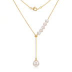 Close-up product shot of a double Akoya pearl drop necklace in 18K solid yellow gold, featuring a 3.5mm pearl and a 7.5mm pearl with rose-pink overtones on a white background.