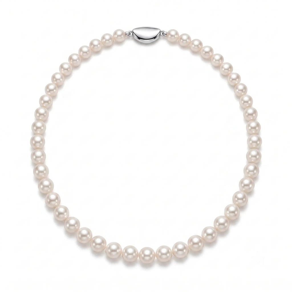 Wedding flatlay featuring a meticulously handcrafted white pearl strand alongside bridal accessories and invitations.