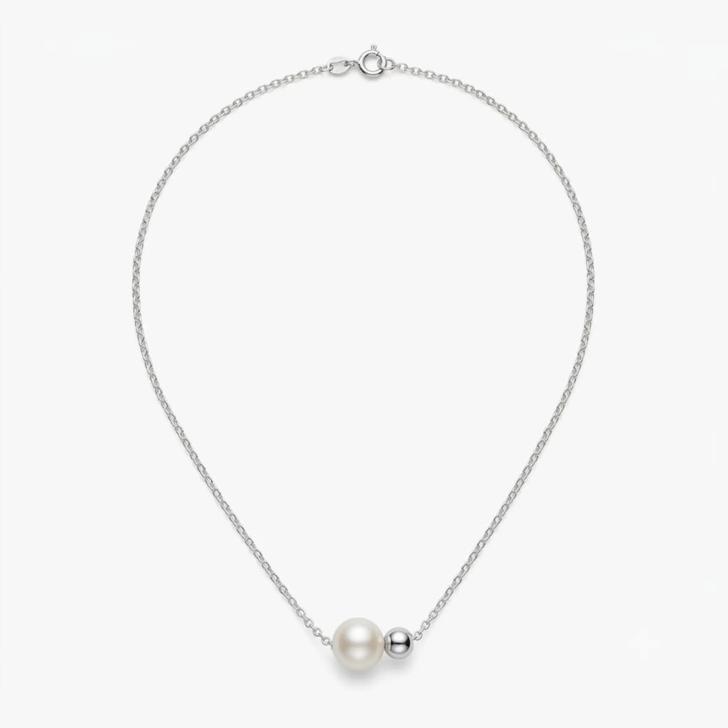 Studio shot of the asymmetrical 18K white gold plated sterling silver necklace on a clean white background.