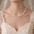 Woman wearing a multi-strand freshwater pearl collar necklace for an elegant old-money inspired jewelry look.