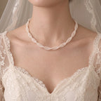 Woman wearing a multi-strand freshwater pearl collar necklace for an elegant old-money inspired jewelry look.